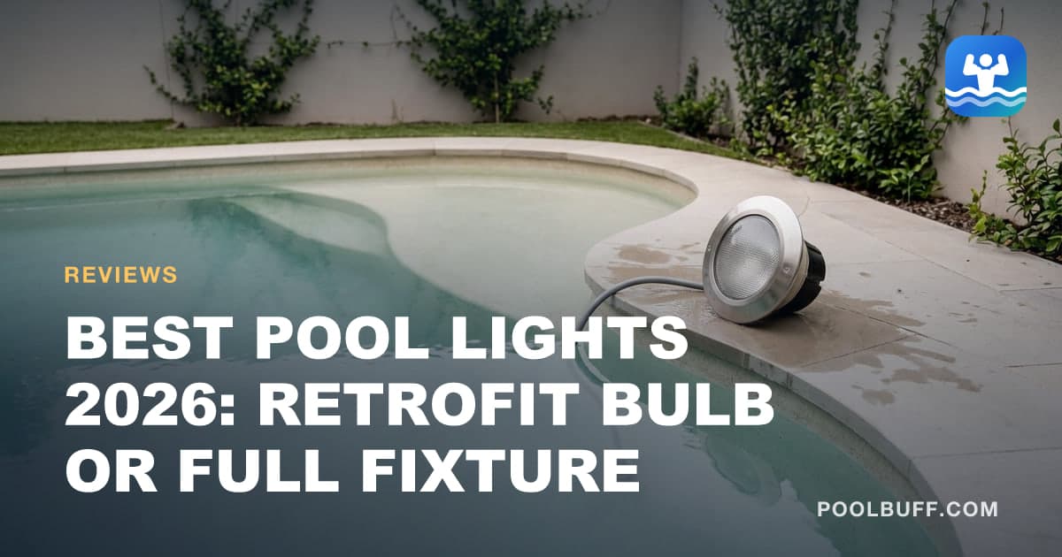A pool light fixture lifted out of its niche and resting on wet coping beside a full pool