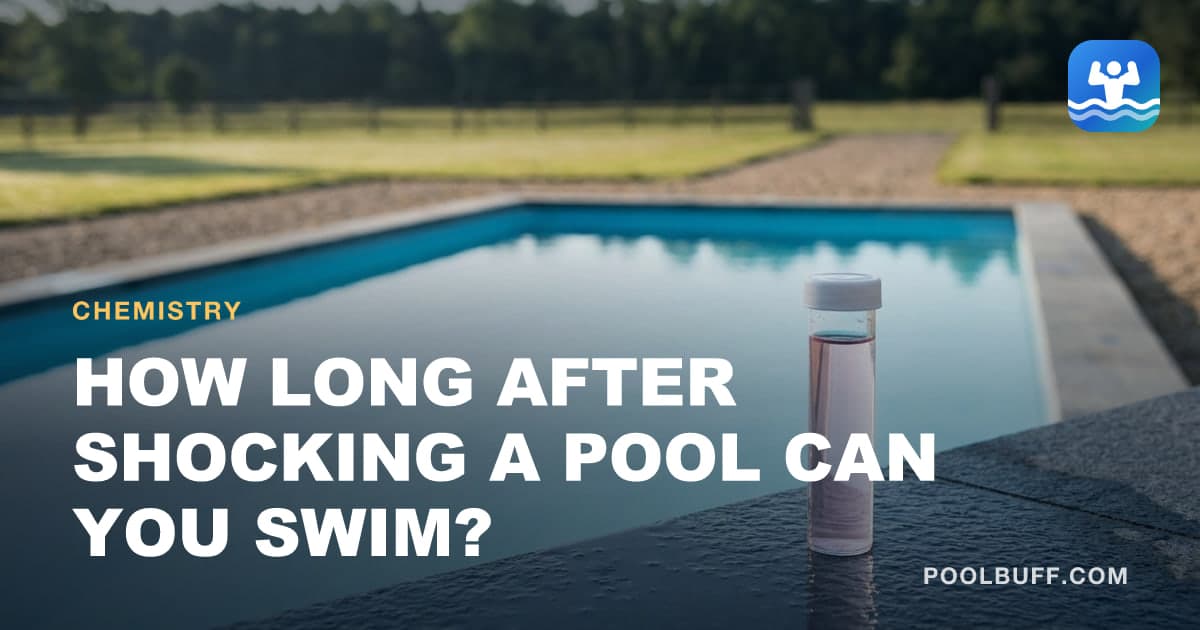 A capped test vial of pale pink pool water standing on wet dark stone coping, a rectangular pool and fenced pasture behind it
