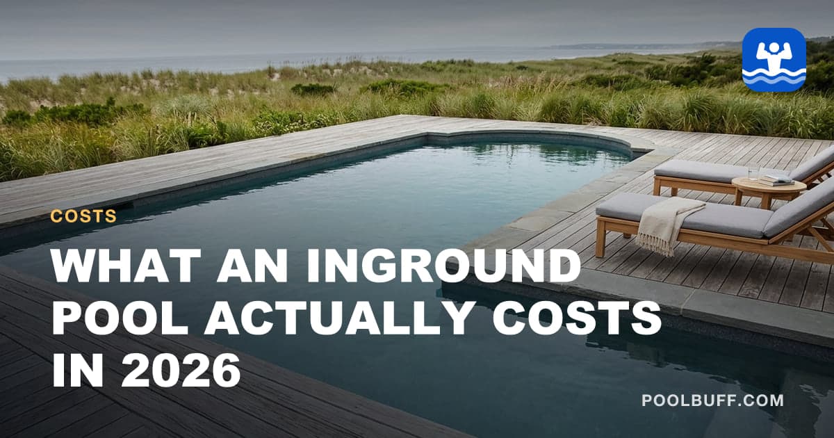 A large rectangular inground pool with stone coping and lounge seating