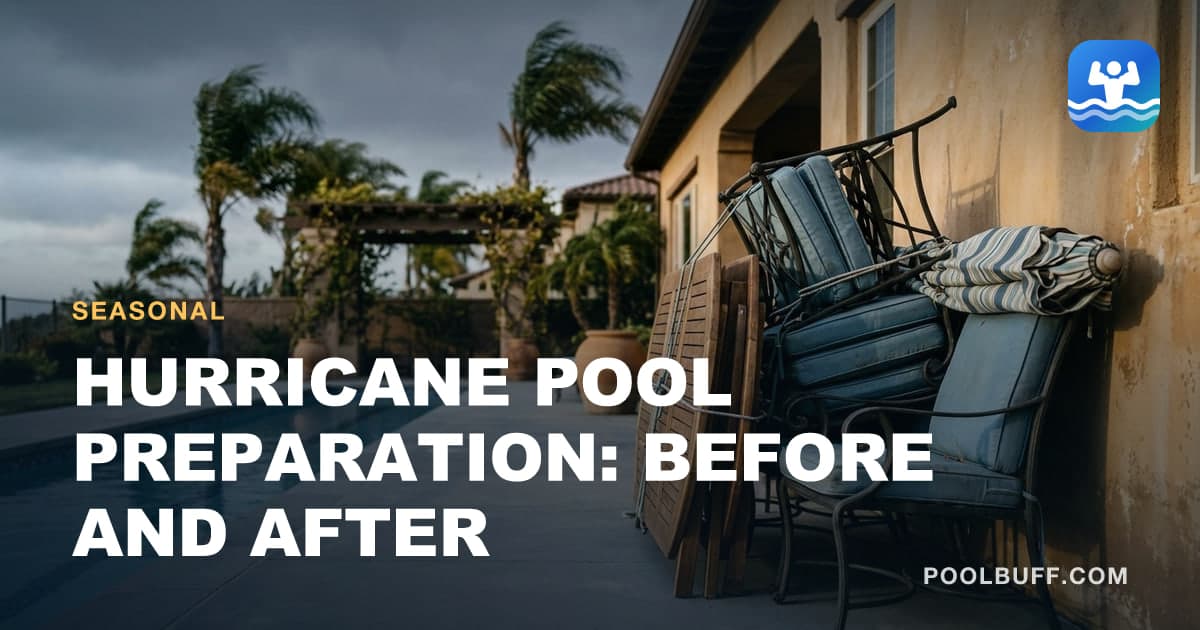 Patio furniture stacked and lashed against a house wall beside a pool, the sky heavy and gray, palm fronds bending in one direction