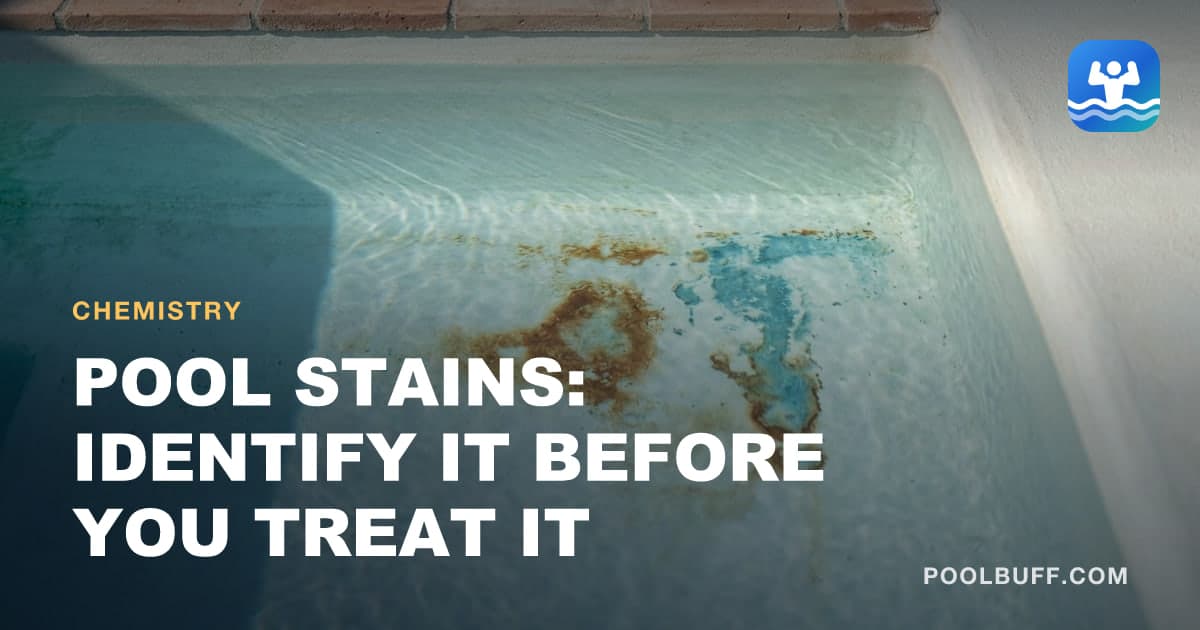 Rust-brown and blue-green stains on pale plaster under clear water