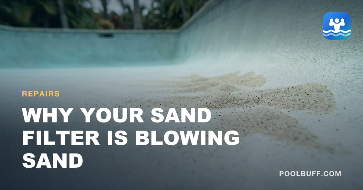 A fan of pale sand grains spread across the speckled white floor of a pool, the lower wall and a line of palms out of focus behind